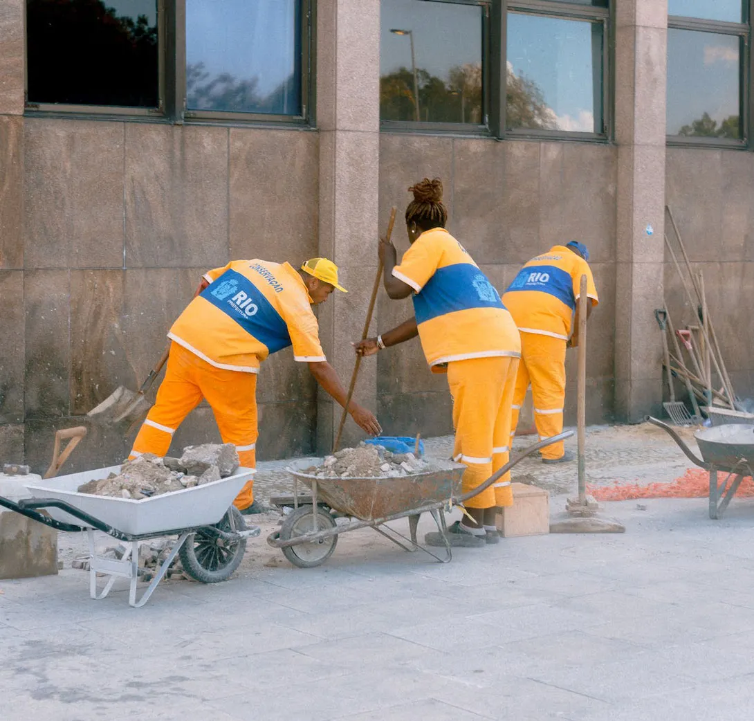 Cleaners cleaning up after a construction work