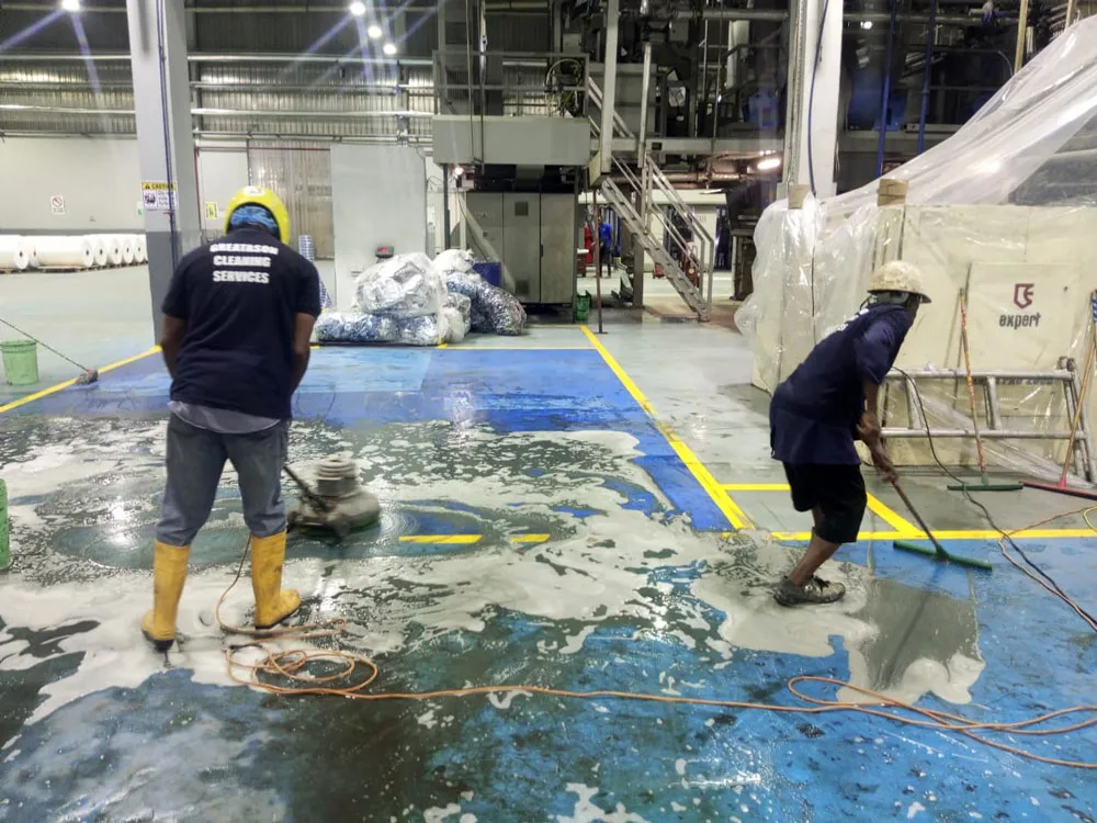 GREATASON cleaners cleaning the floor of a factory